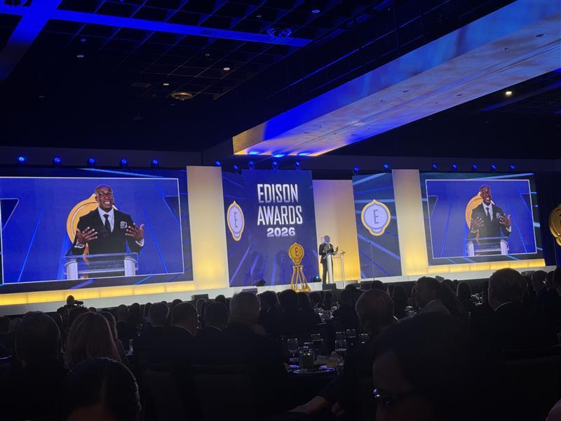 The stage for the Edison Awards. A room full of people sat watching the awards being presented.