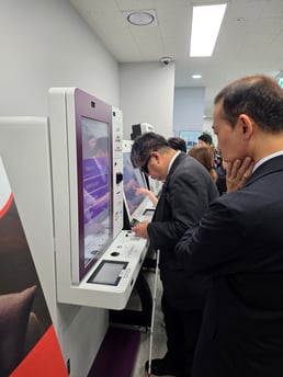 A blind male visitor tries out the Dot Kiosk as part of the Japanese visit. 