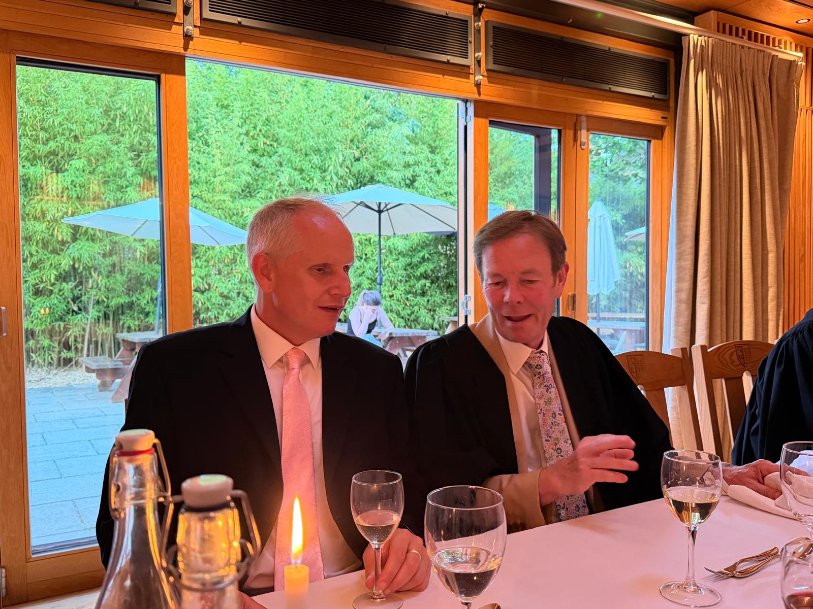 Dave Williams seated at dinner with the College President